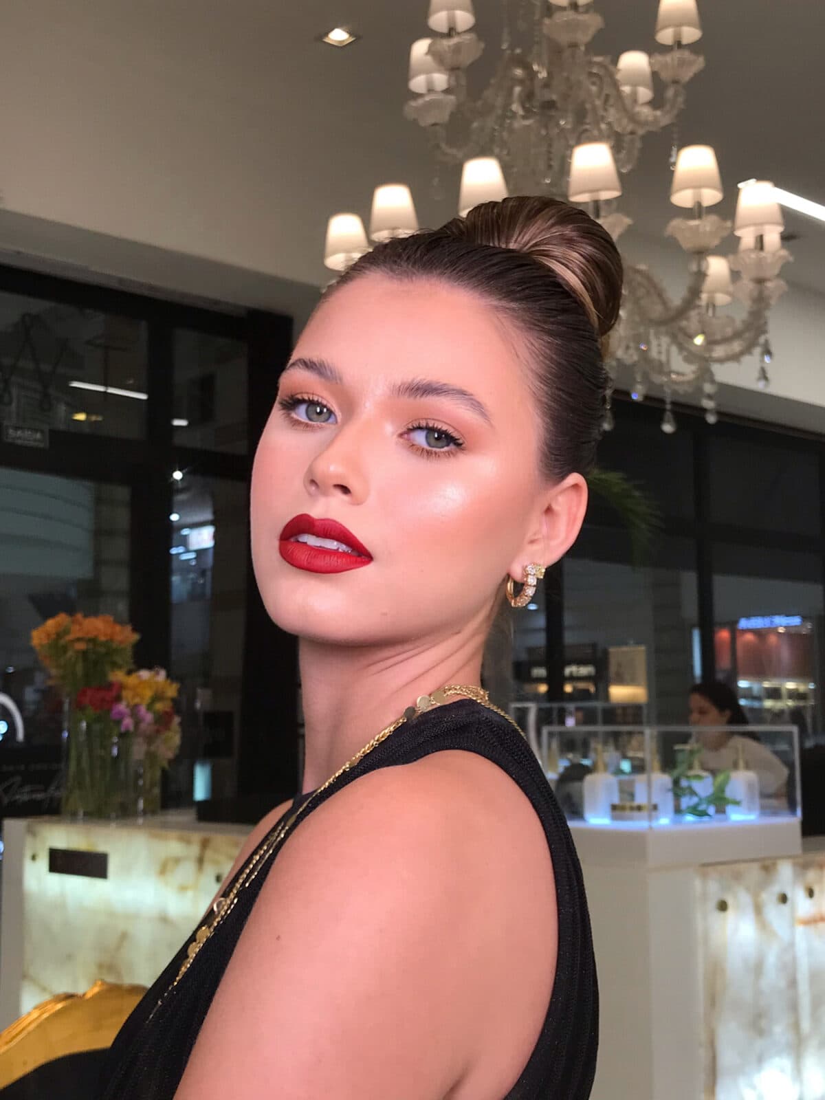 Produção glam para evento com coque e batom vermelho